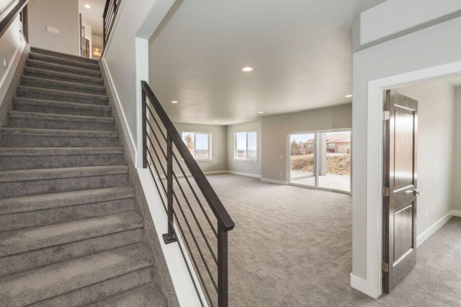 carpeted stairs leading down to an newly finished basement